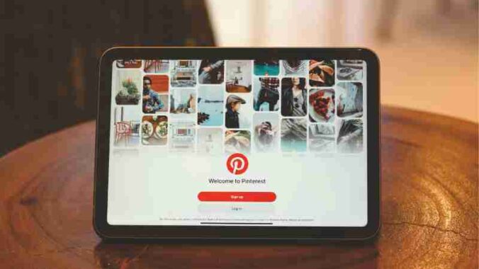 Tablet showing Pinterest login screen on a wooden table indoors., tags: 2026 und - pexel